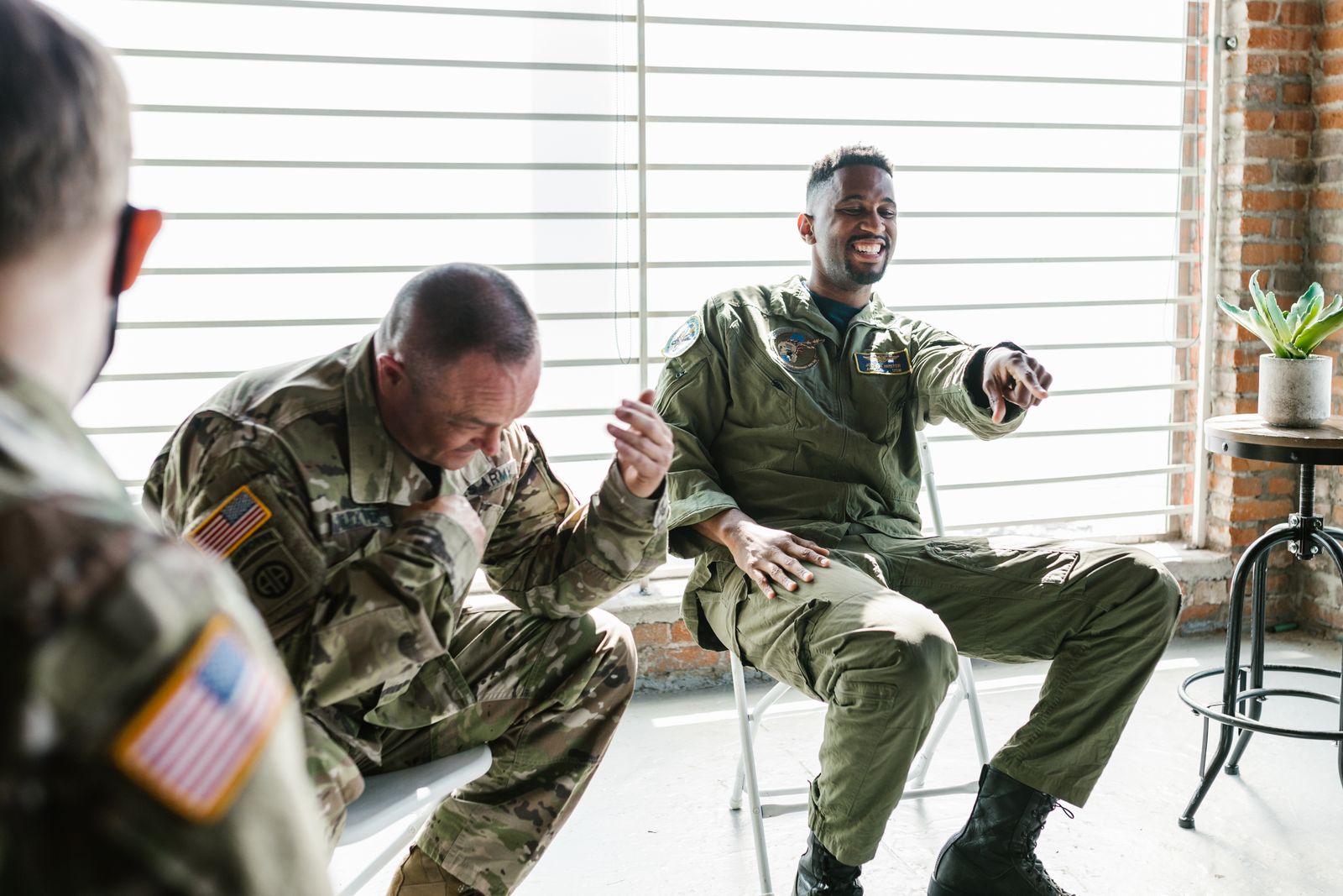 Veterans in uniform sitting together during a supportive group session