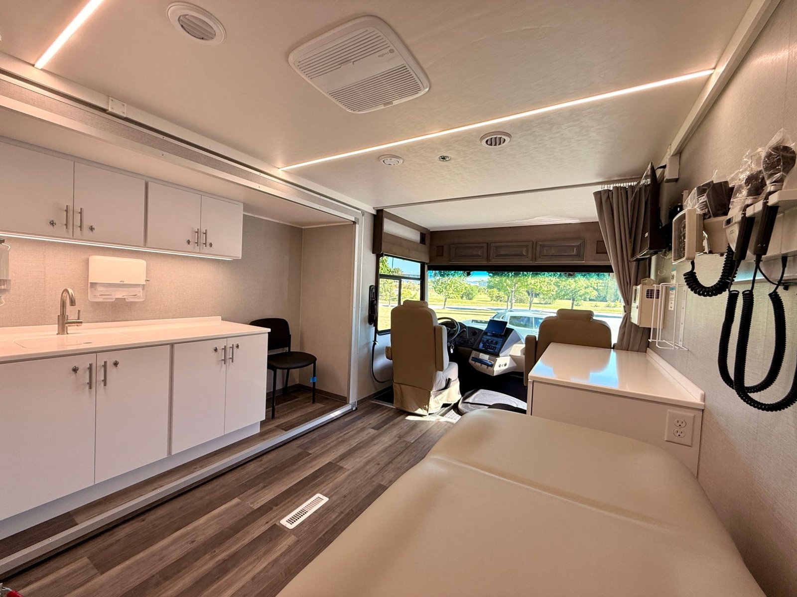 Exam bay looking forward to the cab, with diagnostic wall unit and full-length counter