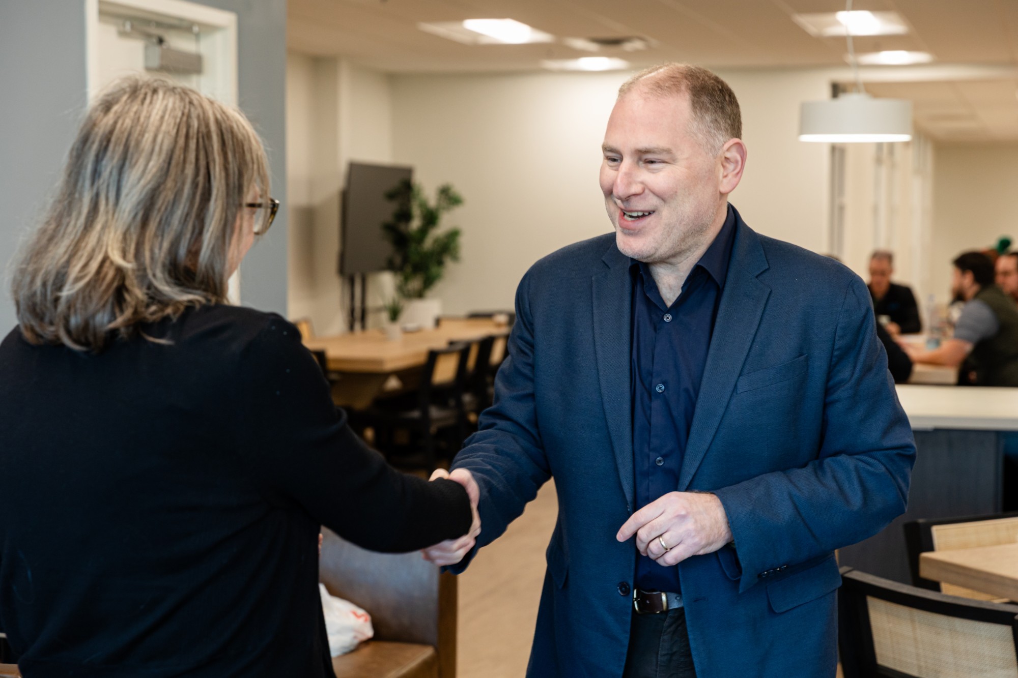 Dr. Paul Rosen, Chief Quality Officer, greeting a colleague at Mission Mobile Medical