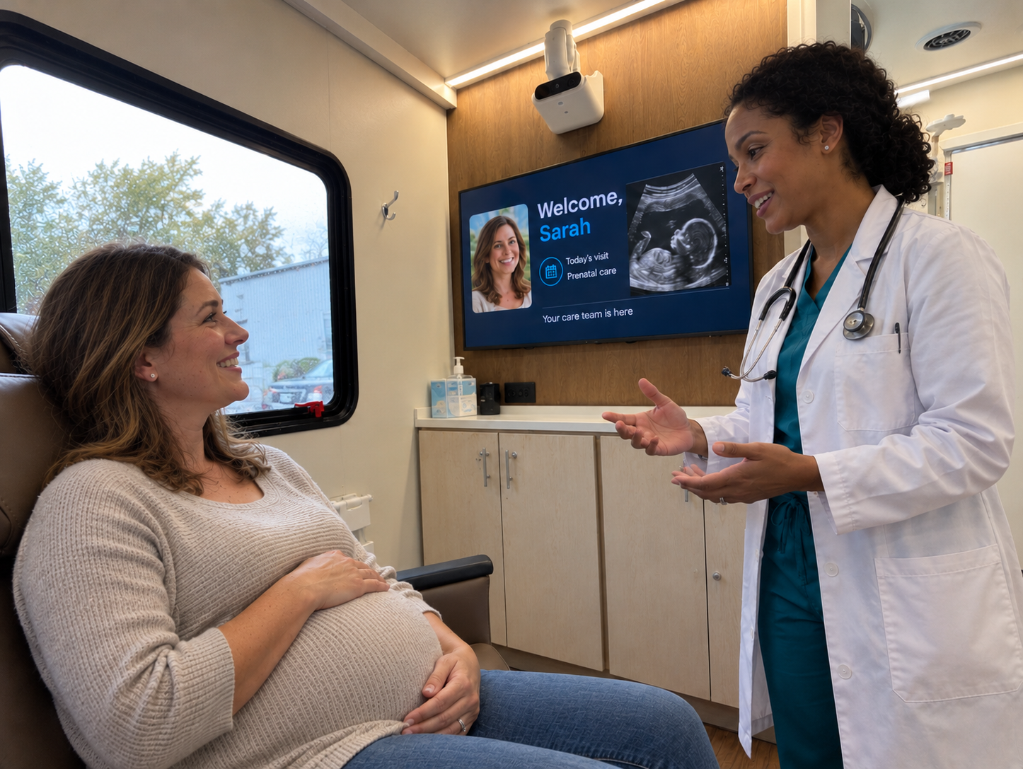 Pregnant patient speaking with a clinician inside a mobile clinic